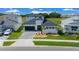 Beautiful contemporary home with a stylish dark garage door, desert landscaping, and vibrant green lawn at 10549 Torchwood Sea Way, San Antonio, FL 33576