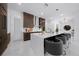 Modern kitchen featuring a large island with seating, stainless steel appliances, and dark wood cabinetry at 10549 Torchwood Sea Way, San Antonio, FL 33576