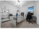 Contemporary home office with white desk, modern lighting, and carpeted floor at 10549 Torchwood Sea Way, San Antonio, FL 33576