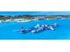 Community water park featuring inflatable water slides and structures in the lake at 10549 Torchwood Sea Way, San Antonio, FL 33576