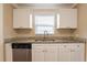 Updated kitchen featuring granite countertops, a stainless steel dishwasher, and white cabinets at 2333 33Rd S St, St Petersburg, FL 33712