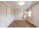 A spacious living room with wood-look flooring features beadboard and white trim at 2333 33Rd S St, St Petersburg, FL 33712