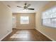 Bright living room featuring modern flooring, a ceiling fan, and natural light through large windows at 2333 33Rd S St, St Petersburg, FL 33712