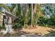 Backyard featuring lush landscaping, a screened-in porch, and native Florida foliage at 2902 Little Rd, Valrico, FL 33596