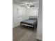 Simple bedroom with neutral tones, ceiling fan, and natural light at 2902 Little Rd, Valrico, FL 33596
