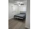 Comfortable bedroom featuring wood-look floors, white trim, and a ceiling fan at 2902 Little Rd, Valrico, FL 33596