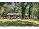 Charming one-story brick home with a well-maintained front yard and mature trees at 2902 Little Rd, Valrico, FL 33596