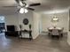 Open-concept living room and dining area with modern chandelier and ceiling fan at 2902 Little Rd, Valrico, FL 33596