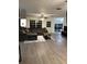 Spacious living room with wood-look floors, modern furniture, and natural light at 2902 Little Rd, Valrico, FL 33596