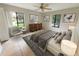 Comfortable bedroom featuring tile floors, ceiling fan, large windows and neutral wall color at 1424 Pine Glen Ln # D2, Tarpon Springs, FL 34688