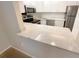 Contemporary kitchen featuring stainless steel appliances, white cabinets, and ample countertop space at 1424 Pine Glen Ln # D2, Tarpon Springs, FL 34688