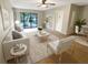 Bright living room featuring a large window, neutral-toned walls, modern furnishings, and tile flooring at 1424 Pine Glen Ln # D2, Tarpon Springs, FL 34688