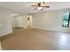 Bright living room featuring tile flooring, neutral-toned walls, a ceiling fan and ample natural light at 1424 Pine Glen Ln # D2, Tarpon Springs, FL 34688
