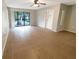Spacious living room boasting a large window and neutral-toned walls with tile flooring at 1424 Pine Glen Ln # D2, Tarpon Springs, FL 34688