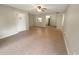 Open-concept living room with tile flooring, neutral walls, and view into the kitchen with stainless steel appliances at 1424 Pine Glen Ln # D2, Tarpon Springs, FL 34688