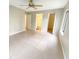 An open main bedroom has tile floors, neutral paint, large window, ceiling fan and connected bath at 1424 Pine Glen Ln # D2, Tarpon Springs, FL 34688