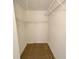 This walk-in closet features neutral paint, tile flooring, wire shelves, and ceiling light at 1424 Pine Glen Ln # D2, Tarpon Springs, FL 34688