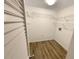 A walk-in closet with wooden floors, wire racks and a utility hookup provides storage space at 1424 Pine Glen Ln # D2, Tarpon Springs, FL 34688