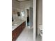 Bathroom featuring double sinks and vanities with bright lighting at 4435 Tevalo Dr, Valrico, FL 33596