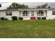 Inviting single-story home featuring a cozy front porch and a well-manicured front lawn at 4435 Tevalo Dr, Valrico, FL 33596