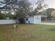 Detached garage with a carport in a spacious backyard setting at 4435 Tevalo Dr, Valrico, FL 33596