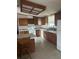 Functional kitchen with wooden cabinets, tile flooring, and modern appliances at 4435 Tevalo Dr, Valrico, FL 33596