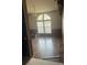Bright living room featuring hardwood floors, large windows, and a stylish chandelier at 4435 Tevalo Dr, Valrico, FL 33596