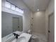 Contemporary bathroom features a sleek vanity, tiled shower, and modern light fixture at 2346 Logsdon St, North Port, FL 34287