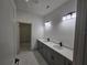 Primary bathroom featuring double sinks and contemporary lighting at 2346 Logsdon St, North Port, FL 34287