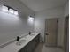 Double vanity in Primary bath featuring modern fixtures and granite counters at 2346 Logsdon St, North Port, FL 34287