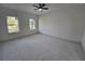 Bright room featuring white marble floors, natural light from two windows, and ceiling fan at 2346 Logsdon St, North Port, FL 34287