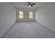 Spacious room featuring white marble floors, natural light from two windows, and ceiling fan at 2346 Logsdon St, North Port, FL 34287