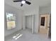 Bedroom featuring a window with backyard views and ample closet space at 2346 Logsdon St, North Port, FL 34287