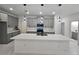 Modern kitchen featuring gray cabinets, a large island, and contemporary lighting fixtures at 2346 Logsdon St, North Port, FL 34287