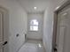 Bright laundry room features tile flooring, window for natural light, and utility connections at 2346 Logsdon St, North Port, FL 34287