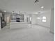 Open concept living room with white marble tile floors and modern lighting, open to kitchen at 2346 Logsdon St, North Port, FL 34287