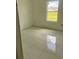 Bright bedroom with tile floors and a view of a grassy yard at 24462 Cabana Rd, Punta Gorda, FL 33955