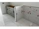 Newly installed gray kitchen cabinets and backsplash, complemented by modern marble tile flooring at 24462 Cabana Rd, Punta Gorda, FL 33955