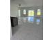 Open-concept living room with sliding glass doors and tile flooring throughout the home at 24462 Cabana Rd, Punta Gorda, FL 33955