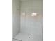 Shower stall featuring floor to ceiling tile and hexagon tile flooring at 24462 Cabana Rd, Punta Gorda, FL 33955