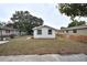 Rear view of house showing flat backyard, updated windows, and fresh landscaping at 316 21St W St, Palmetto, FL 34221