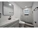 Modern bathroom featuring gray vanity, black hardware, and tiled walk-in shower at 316 21St W St, Palmetto, FL 34221