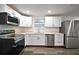 Modern kitchen showcasing stainless steel appliances, white cabinetry, and quartz countertops, perfect for culinary enthusiasts at 316 21St W St, Palmetto, FL 34221