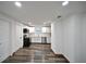 Renovated kitchen featuring stainless steel appliances, white cabinets, and contemporary flooring at 316 21St W St, Palmetto, FL 34221