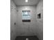Walk-in shower with marbled tile and black tiled inset at 316 21St W St, Palmetto, FL 34221