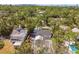 Stunning aerial view of a private residence showcasing a pool and lush landscape amongst tropical trees at 913 Tennessee Ln, Sarasota, FL 34234