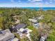 Idyllic aerial shot of a home with a private pool and patio, nestled among lush greenery with ocean view at 913 Tennessee Ln, Sarasota, FL 34234