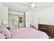 Bright bedroom featuring closet, ceiling fan and a glimpse of hardwood flooring in adjacent room at 913 Tennessee Ln, Sarasota, FL 34234