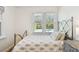 Bright bedroom featuring a window with views of the outdoor pool at 913 Tennessee Ln, Sarasota, FL 34234