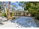Wide driveway with white gravel and lush greenery, leading to a charming home at 913 Tennessee Ln, Sarasota, FL 34234